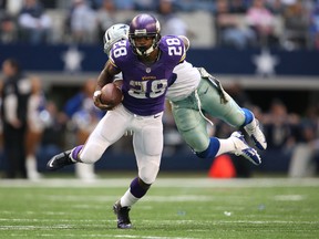Minnesota Vikings running back Adrian Peterson (28) runs with ball against Dallas Cowboys linebacker Ernie Sims (59) in the second quarter at AT&T Stadium on Nov 3, 2013 in Arlington, TX, USA. (Matthew Emmons/USA TODAY Sports)