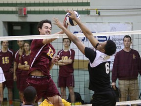 David Spies of the Regiopolis-Notre Dame Panthers battles at the net with Khalil Darby of Toronto’s Francis Libermann Falcons during an opening-day match at the Ontario boys AAA volleyball championship at Holy Cross on Thursday. (Ian MacAlpine/The Whig-Standard)