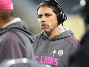 B.C. Lions head coach Mike Benevides speaks to his coaches on the sideline during CFL action against the Winnipeg Blue Bombers at Investors Group Field in Winnipeg, Man., on Sat., Oct. 25, 2014. (Kevin King/QMI Agency)