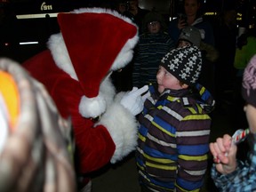Santa meets six-year-old Dallas MacLeod at last year's lighting of the downtown Christmas tree. Santa returns as guest of honour at the St. Thomas Optimist Santa Claus Parade on Saturday on Talbot St., starting 6 p.m. at First Ave. 
Eric Bunnell/Times-Journal