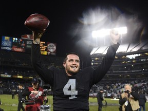 Oakland Raiders quarterback Derek Carr (4) celebrates after the game against the Kansas City Chiefs at O.co Coliseum on November 20, 2014 in Oakland, CA, USA. (Kyle Terada/USA TODAY Sports)