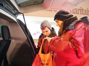 Gino Donato/The Sudbury Star
Community Outreach workers Dan Charest and Megan O'Byrn sort through items that were to be given away during the city's first extreme cold weather alert on Thursday night at the Samaritan Centre. Temperatures were to dip to around -18 C last night.