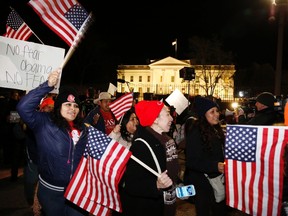 Supporters of U.S. president Barack Obama march in front of the White House in Washington, D.C., Nov. 20, 2014. (LARRY DOWNING/Reuters)