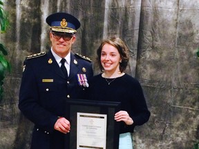 Emily Williamson receiving her OPP Commissioners Citation for LifeSaving from OPP Commissioner Vince Hawkes.  The ceremony took place on Thursday Nov. 20, 2014 at the Hilton in London.