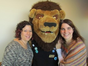 St. Patrick's Catholic High School teachers Denise Chaulk, left, and Karoline Lobsinger get a hug from Lambton College mascot Pounce during a professional development day held Friday at the college for staff from the Sarnia secondary school. PAUL MORDEN/ THE OBSERVER/ QMI AGENCY
