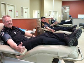 Brian Freer (left) Mike Vasey and Bubba Lyon get ready to give blood at Bayside Mall in honour of their former colleague George Klazinga. Klazinga, a comrade with the men as a member of the volunteer fire department in Wyoming, died earlier this year.
BRENT BOLES / QMI Agency