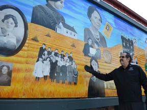Stony Plain mural tour guide Greg Hanna admires the new Cornelia Wood mural at the Stony Plain United Church during its dedication ceremony on Nov. 13. The mural, called “Reflections,” depicting the former mayor and MLA, was painted by local artist Tina Bourassa. - Thomas Miller, Reporter/Examiner
