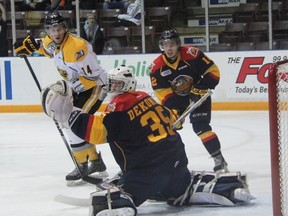 Sarnia Sting forward Pavel Zacha, Erie Otters goalie Daniel Dekoning and forward Alex DeBrincat watch a puck deflect past the net during OHL action Friday night in Sarnia. Erie collected a 7-1 victory. (TERRY BRIDGE, The Observer)