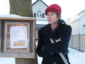 Christine Montgomery isn?t happy the city of London has asked her to remove her poetry window from a tree in front of her home. (DEREK RUTTAN, The London Free Press)