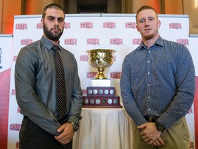 Gabriel Cousineau, quarterback of the Montreal Carabins (left), and Manitoba Bisons QB Jordan Yantz pose with the Uteck Bowl (JOEL LEMAY/QMI Agency)