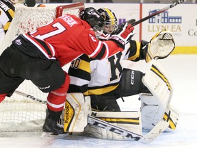 Owen Sound Attack's Zach Nastasiuk collides with Kingston Frontenacs goaltender Lucas Peressini during the first period of Friday night's Ontario Hockey League game at the Rogers K-Rock Centre.