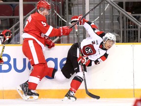 Ottawa 67's winger Jeremiah Addison takes some contact to make a play during the first period of Friday's game between Ottawa and the Sault Ste. Marie Greyhounds at TD Place. (Chris Hofley/Ottawa Sun)