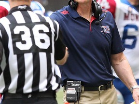 Montreal Alouettes Head Coach Tom Higgins (right) talks with an official during the first half of CFL game against the BC Lions at BC Place in Vancouver, B.C. on Saturday July 19, 2014. (Carmine Marinelli/QMI Agency)