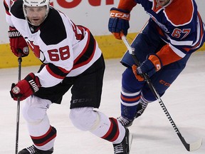 Devils forward Jaromir Jagr is chased by Oilers forward Benoit Pouliot during first-period action Friday at Rexall Place. (David Bloom, Edmonton Sun)