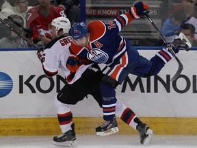 Edmonton's Jordan Eberle checks New Jersey's Andy Greene Friday night at Rexall Place (David Bloom, Edmonton Sun).