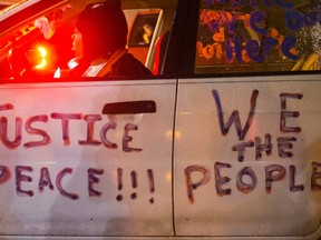 A protester sits in her vehicle outside the Ferguson Police Department in Missouri, Nov. 21, 2014. (ADREES LATIF/Reuters)