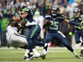 Seattle Seahawks cornerback Richard Sherman (25) carries the ball after catching an interception against the Oakland Raiders at CenturyLink Field on Nov 2, 2014 in Seattle, WA, USA. (Steven Bisig/USA TODAY Sports)
