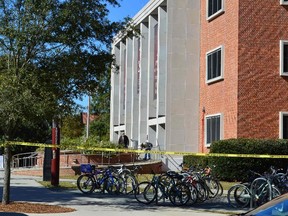 Crime scene tape is seen in front of the library at Florida State University, in Tallahassee, Fla., on November 20, 2014. Three students were shot and wounded when a gunman opened fire inside the main Florida State University library early on Thursday, and campus police shot the suspect dead, officials said. (REUTERS/Bil Cotterell)
