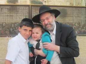 Howie Rothman and his sons Binyomin, far left, and Akiva in November 2013. (Photo courtesy the Rothman family)