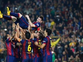 Barcelona's Lionel Messi celebrates his goal with teammates during their Spanish first division soccer match against Sevilla at Nou Camp stadium in Barcelona November 22, 2014. (REUTERS/Gustau Nacarino)