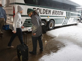 Fullback Calvin McCarty (right) heads to his bus as the Edmonton Eskimos CFL football team leaves for Calgary to face the Calgary Stampeders in the CFL Western Final at Commonwealth Stadium in Edmonton, Alta., on Saturday, Nov. 22, 2014. The Eskimos take on the Stampeders for a berth in the Grey Cup at McMahon Stadium in Calgary on Sunday, Nov. 23. Ian Kucerak/Edmonton Sun/ QMI Agency
