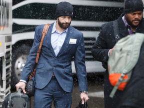 Quarterback Mike Reilly (left) heads to one of three buses as the Edmonton Eskimos CFL football team left for Calgary to face the Calgary Stampeders in the CFL Western Final at Commonwealth Stadium in Edmonton, Alta., on Saturday, Nov. 22, 2014. The Eskimos take on the Stampeders for a berth in the Grey Cup at McMahon Stadium in Calgary on Sunday, Nov. 23. Ian Kucerak/Edmonton Sun/ QMI Agency