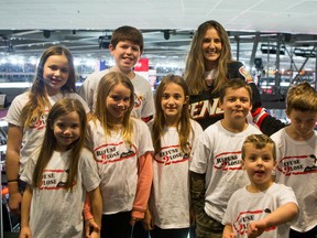 Dev Jude (in Sens jersey) stands with a group of young Refuse2Lose Team Bryce volunteers at the Saturday, Nov. 22, 2014 Senators game. Dev's seven-year-old son, Bryce, died in 2012 and the group has since committed to funding the Candlelighter's Suite Seats program at Canadian Tire Centre. The suite is designed to be a safe place for kids undergoing cancer treatments to watch live hockey or other events at the stadium. 
CHRIS HOFLEY/OTTAWA SUN/QMI AGENCY