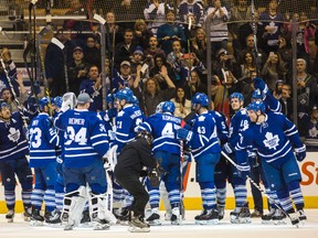 The Maple Leafs salute the fans, though not from centre ice, following their 4-1 win over the Red Wings at the ACC Nov. 22, 2014. (ERNEST DOROSZUK, Toronto Sun)