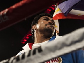 Manny Pacquiao of the Philippines enters the ring before the start of his fight against Chris Algieri of the US for the world welterweight championship boxing title at the Cotai Arena in Macau on November 23, 2014.    AFP PHOTO / XAUME OLLEROS