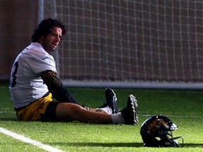 Andy Fantuz stretches during Hamilton Tiger-Cats practice at Players Paradise Sports Complex in Stoney Creek, Ont, on Tuesday November 18, 2014. Dave Abel/Toronto Sun/QMI Agency