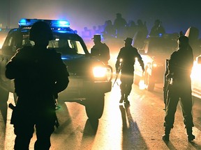 Afghan security forces arrive at the site of a suicide car bomb at the gate of Green Village compound, a large fortified complex where many foreign employees live and work in Kabul, in this November 19, 2014 file photo. (AFP PHOTO/Shah Marai)