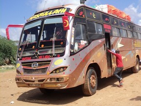 Rescue workers walk near a Nairobi-bound bus that was ambushed outside Mandera town, near Kenya's border with Somalia and Ethiopia, November 22, 2014.  REUTERS/Stringer