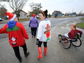 A group of members at The Right Fit on Maitland Drive in Belleville, Ont., some of their friends and family members take the start of the private fitness studio's fourth annual Santa Run in support of the Canadian Cancer Society Wheels of Hope Sunday morning, Nov. 23, 2014. - JEROME LESSARD/THE INTELLIGENCER/QMI AGENCY