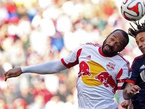 New York Red Bulls forward Thierry Henry (14) and New England Revolution midfielder Jermaine Jones (13) attempt to head the ball during the first half of the Eastern Conference Championship at Red Bull Arena on Nov 23, 2014 in Harrison, NJ, USA. (Noah K. Murray/USA TODAY Sports)