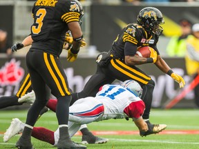 Hamilton Tiger-Cats Terrell Sinkfield and Montreal Alouettes Chip Cox at Tim Hortons Field during the 1st half of the CFL Eastern Final in Hamilton, Ont. on Sunday November 23, 2014. (Ernest Doroszuk/QMI Agency)