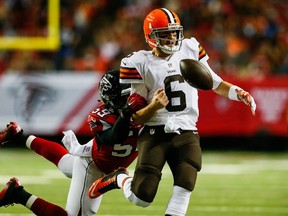 Brian Hoyer #6 of the Cleveland Browns loses the ball out of bounds under pressure by Joplo Bartu #59 of the Atlanta Falcons in the first half at Georgia Dome on November 23, 2014 in Atlanta, Georgia. (Kevin C. Cox/Getty Images/AFP)