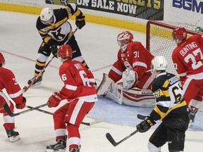 Kingston Frontenacs' Spencer Watson tries to knock the bouncing puck past Sault Ste. Marie Greyhounds goaltender Brandon Halverson during the third period of Ontario Hockey League action at the Rogers K-Rock Centre on Sunday. Watson scored the only Kingston goal as the Fronts lost 3-1. (Julia McKay/The Whig-Standard)