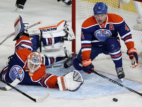 Taylor Hall and goalie Ben Scrivens face another barrage of opposition shots (David Bloom, Edmonton Sun).