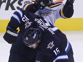 Winnipeg Jets forward Matt Halischuk (bottom) and St. Louis Blues defenceman Ian Cole collide during NHL action at MTS Centre in Winnipeg, Man., on Sun., Nov. 23, 2014. (Kevin King/Winnipeg Sun/QMI Agency)