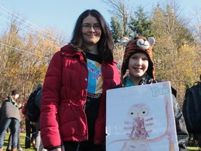 Kate Fink-Jensen (right), 11, crossed the injunction line on Burnaby Mountain Sunday during protest of the proposed Trans Mountain pipeline expansion. 
(Jane Deacon, 24 hours)