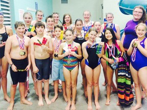 Various members of the Huron Hurricanes Aquatic Club, along with Coach Riley, at the Goderich YMCA sporting their hardware from the Port Elgin meet. (Contributed photo)