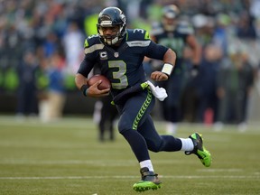 Seattle Seahawks quarterback Russell Wilson (3) rushes for a15-yard gain in the third quarter against the Arizona Cardinals at CenturyLink Field on Nov 23, 2014 in Seattle, WA, USA. (Kirby Lee/USA TODAY Sports)