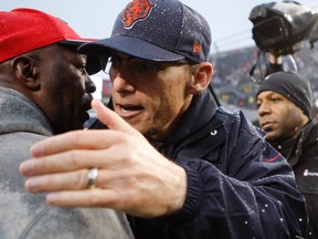 Tampa Bay Buccaneers head coach Lovie Smith (left) greets Chicago Bears head coach Marc Trestman after the Bears' win at Soldier Field on Sunday. (USA TODAY SPORTS/PHOTO)