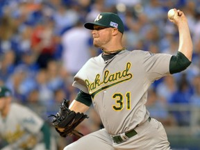 Oakland Athletics starting pitcher Jon Lester (31) throws a pitch against the Kansas City Royals during the first inning of the 2014 American League Wild Card playoff baseball game at Kauffman Stadium on Sep 30, 2014 in Kansas City, MO, USA. (Denny Medley/USA TODAY Sports)