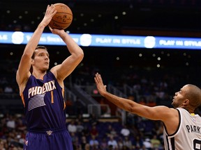 Phoenix Suns guard Goran Dragic (1) shoots the ball against the San Antonio Spurs guard Tony Parker (9) in the first half at US Airways Center on Oct. 16, 2014. (JENNIFER STEWART/USA TODAY Sports)