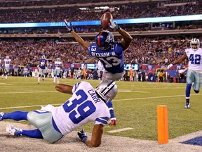 New York Giants wide receiver Odell Beckham (13) catches a touchdown pass over Dallas Cowboys cornerback Brandon Carr (39) during the second quarter at MetLife Stadium on Nov 23, 2014 in East Rutherford, NJ, USA. (Adam Hunger/USA TODAY Sports)