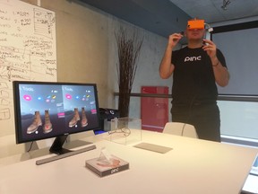 Cordon Media Inc. president Milan Baic demonstrates a shopping app using the Pinc VR headset at his Toronto office on Thursday, Nov. 13, 2014. The computer monitor shows a splitscreen of what Baic sees in the device through each eye. The two images overlayed on top of each other create the 3D effect. (Adam Swimmer/QMI Agency)