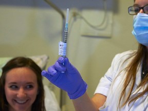 A nurse prepares a syringe containing an experimental Ebola virus vaccine.

REUTERS/Denis Balibouse