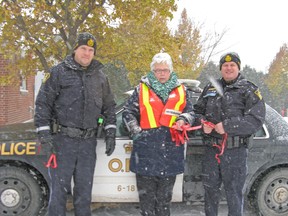 The Huron/Bruce chapter of MADD Canada teamed up with South Bruce OPP and Huron OPP to kick off both the Project Red Ribbon and RIDE programs for the holiday season in Lucknow, Nov. 19. From left: Const. Adam Janes of South Bruce OPP, MADD President Barbara Rintoul, Sgt. Russ Nesbitt of Huron OPP. (Valerie Gillies/Lucknow Sentinel)