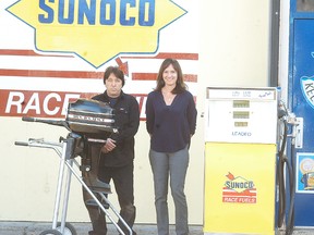 Muddy Waters Keel N' Wheels employees Daryl Fralick and Lia Rudakas stand outside their Elm Street facility. The engine repair shop, restoration and storage facility has now been open for a couple years.